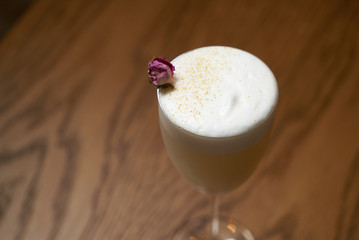 Glass with alcoholic cocktail drink on table, close-up