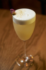 Glass with alcoholic cocktail drink on table, close-up