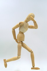 Wooden mannequin figure expressing caught by diarrhea and feeling a shame. 