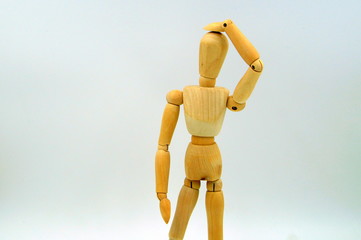 Wooden mannequin figure hand to head - body language bad idea. Oops.