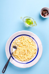Salad Couscous with Olive Oil on a blue background Top View Copy space for Text  Flat Lay