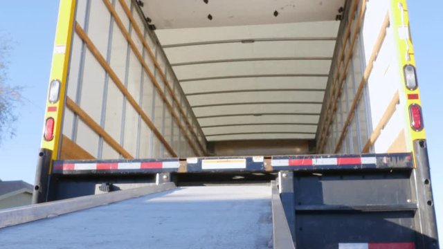 Low angle of a ramp and moving truck in 4k. Wide shot of the empty truck represents relocating for work, a fresh start and transplantation. 
