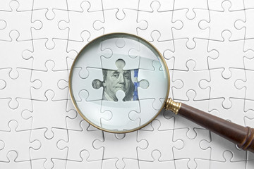 Magnifier and puzzle on money. 