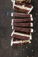 Recipe diet cake on a dark background, sliced into pieces. Vertical. Top view.