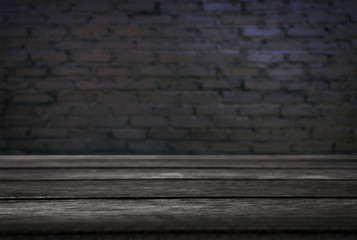 Selected focus empty black wooden table and wall texture or old black brick wall blur background image. for your photomontage or product display