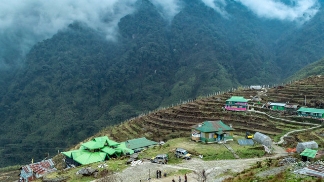 A hilltop View of beautiful misty mountain range with zuluk village.