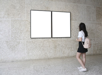 Woman in a gallery looking at empty frames