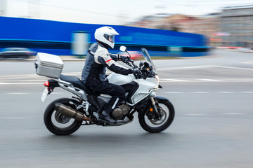 motorcycle rides with speed on city roads
