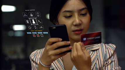 Young Asian Teenage girl using a mobile phone to buy products from an online store with credit card, online surfing and chatting with friends on the social network