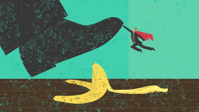 Help Avoiding Mistakes. A miniature, super businessman saves someone from slipping on a banana peel. 