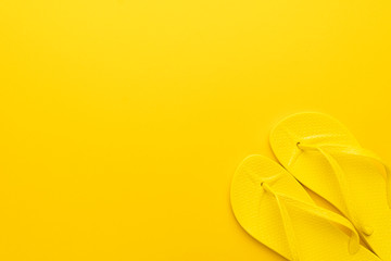 beach flip-flops on the yellow background with copy space. summer concept