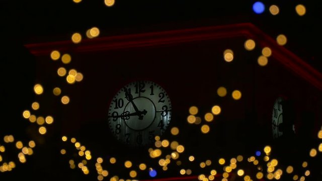Clock tower seen through Christmas decorations