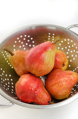Ripe red pears on colander.