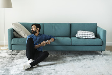 Man using mobile phone on the floor alone
