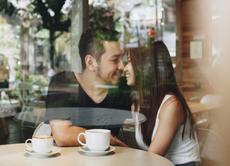Lovely asian couple having coffee