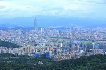 Aerial panorama of Taipei downtown & suburbs at dusk with view of Keelung Riverside Park, MacArthur bridge, Taipei 101 in Xinyi District ~ A romantic night in busy Taipei City in a gloomy blue mood