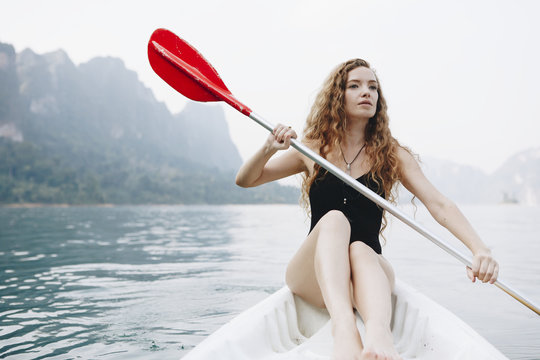 Woman paddling a canoe through a national park