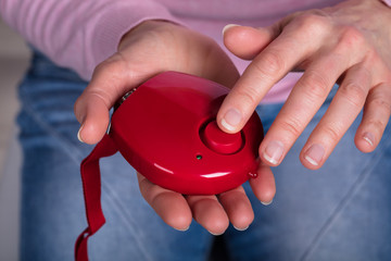 Woman Pressing Personal Alarm Button