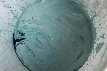 Top shot of mixed grey-blue paint in a bucket