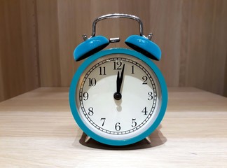 Retro alarm clock on wooden cabinet