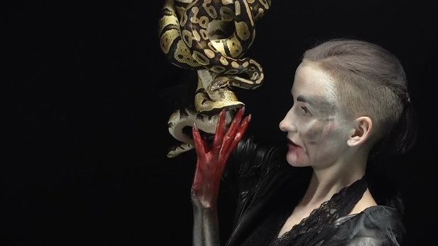 Woman holding two pythons