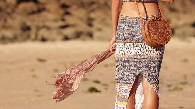 Woman with fashionable stylish rattan bag on the beach. Tropical island of Bali. Handmade Rattan eco handbag HD footage.