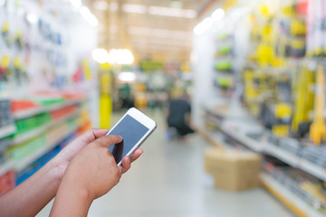 blurred photo smartphone on supermarket store on background with bokeh.