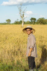 Naklejka na ściany i meble Brown Skin Farmer And His Rice Field