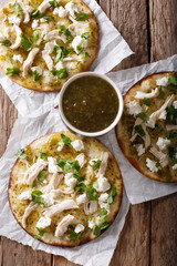 Authentic Mexican Chalupas with farm cheese and chicken meat closeup Vertical top view