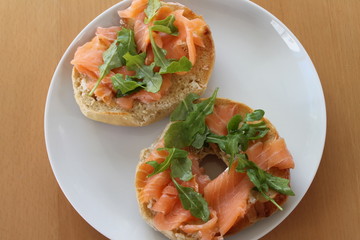 Bagel with arugula and smoked salmon.