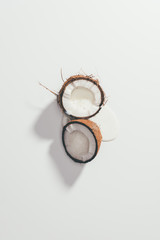 top view of halved organic tasty coconut on white