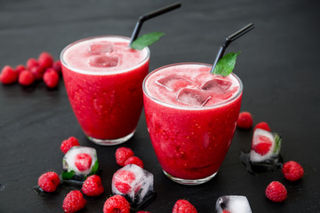 Raspberry cocktail with ice and berries. Tasty fruit smoothie