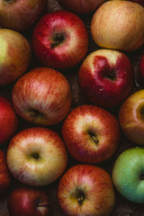 elevated view of pile of apples with water drops on wooden surface