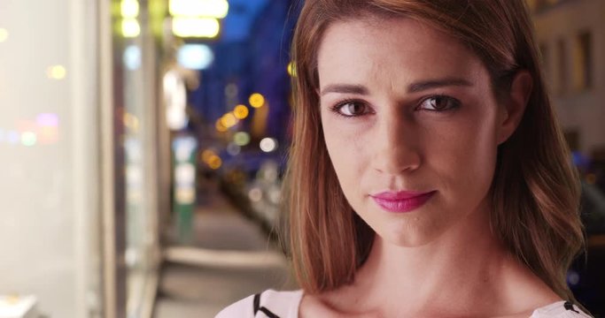 Brown-haired Caucasian Woman Staring At Camera In Metropolitan Setting