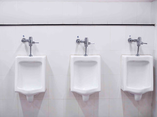 white urinals in public toilet