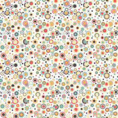 Geometric seamless pattern. The circles of different sizes and colors arranged on a white background. Useful as design element for texture and artistic compositions.