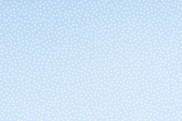 Bright blue paper with white spots and dots texture background.