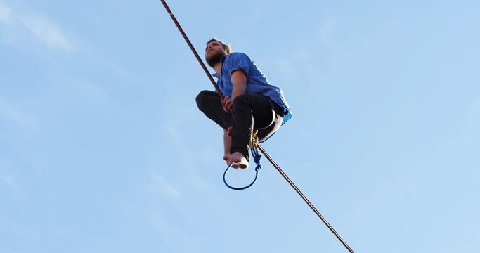 Highline athlete balancing on slack line tight rope 
