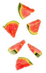 sliced flying watermelon isolated on white background. cut watermelon in pieces isolated on white background. Levity fruit floating in the air.