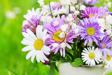 Fototapeta premium Cute bouquet of daisies, carnations, chamomile and lily of the valley flowers.