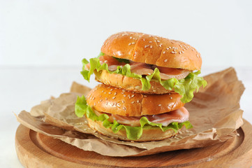 bagel with salmon slices and green salad