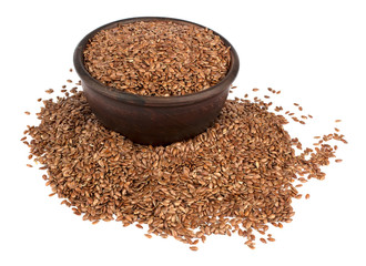 Flax seeds in ceramic bowl isolated on white background.