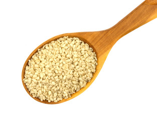 Peeled sesame seeds over white background