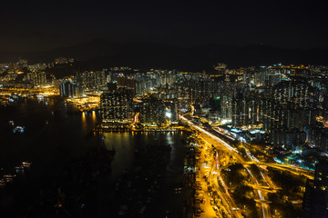 Fototapeta na wymiar Kowloon and Hong Kong harbour aerial view at night