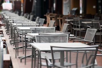 A Few Lined Table at A Open-Air Cafe.