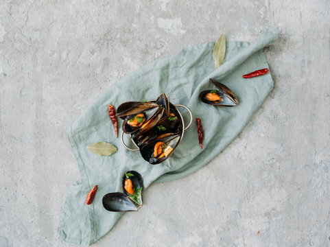 Boiled mussels on linen napkin background. Top view, flat lay