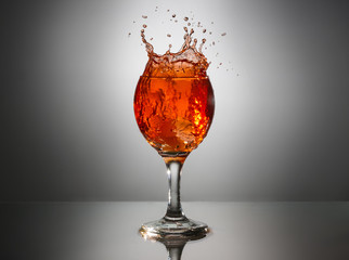 pink wine in a glass on a gray background