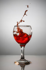 wine in a glass on a gray background