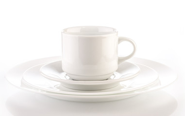 white cup on plates against a white background