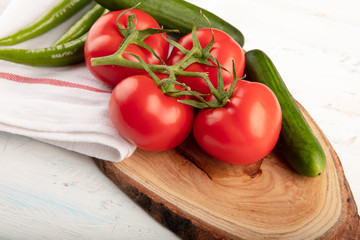 Bunch of red  tomatoes with cucumber and green pepper